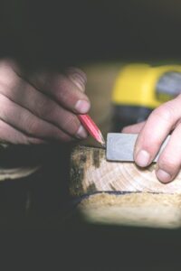 a general contractor in london ky marking a piece of wood