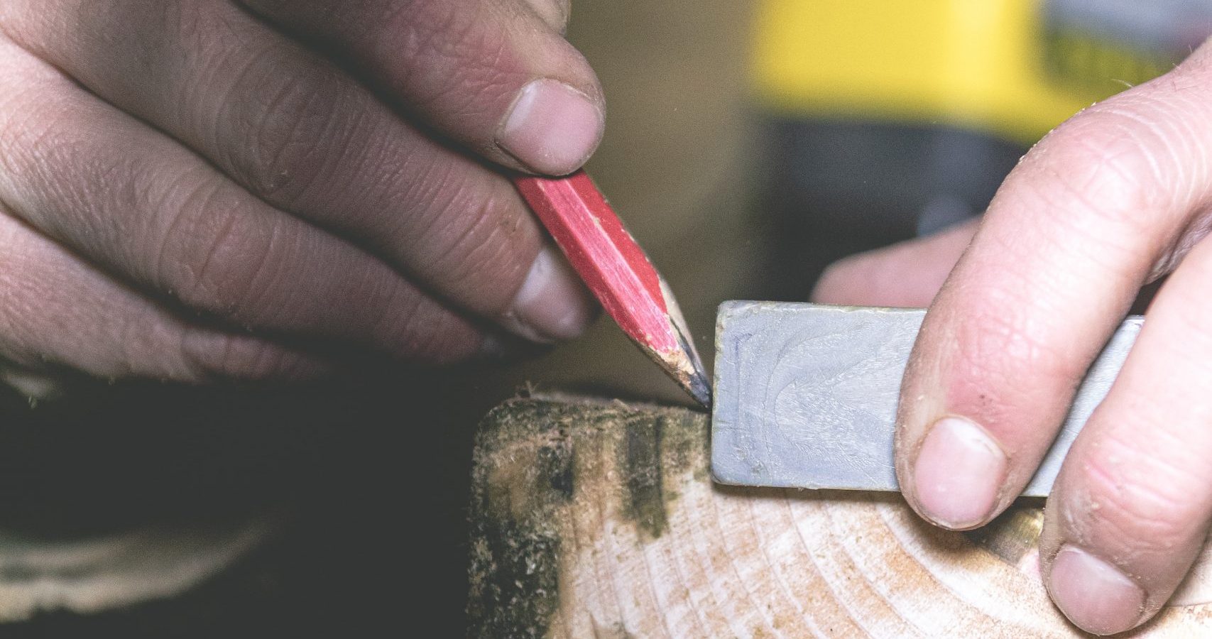 a general contractor in london ky marking a piece of wood